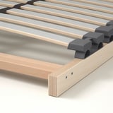 Slatted bed base with adjustable support for comfort. Wooden slats and grey holders for even weight distribution and spine alignment.