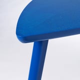 Close-up of vivid blue modern side table with sleek, smooth edges and sturdy finishes.