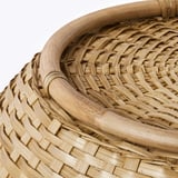 Handwoven bamboo basket, showcasing intricate craftsmanship. Sturdy and well-made with visible bamboo strands.