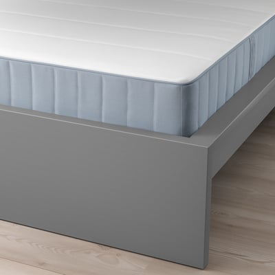 Gray MALM bed with white mattress on wooden floor; high headboard, clean design.