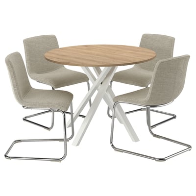 A round wooden dining table surrounded by four beige, cushioned chairs with chrome cantilever legs. Its modern and comfortable.