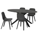 Black circular dining set with modern chairs, marble table, and sleek design
