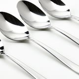 Four shiny, polished metallic spoons arranged neatly in a row, pristine surface reflecting light.