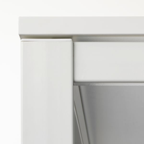 Close-up of white MELLTORP furniture corner, showing sturdy steel legs with quality powder coating.