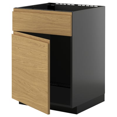 METOD kitchen cabinet with oak drawers and black frame.