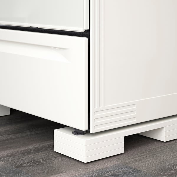 White adjustable appliance feet support kitchen equipment, ensuring proper height alignment with cabinets.