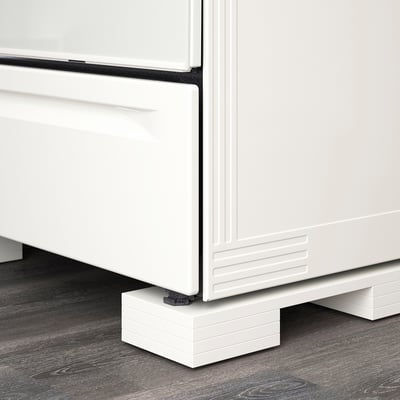 White adjustable appliance feet support kitchen equipment, ensuring proper height alignment with cabinets.