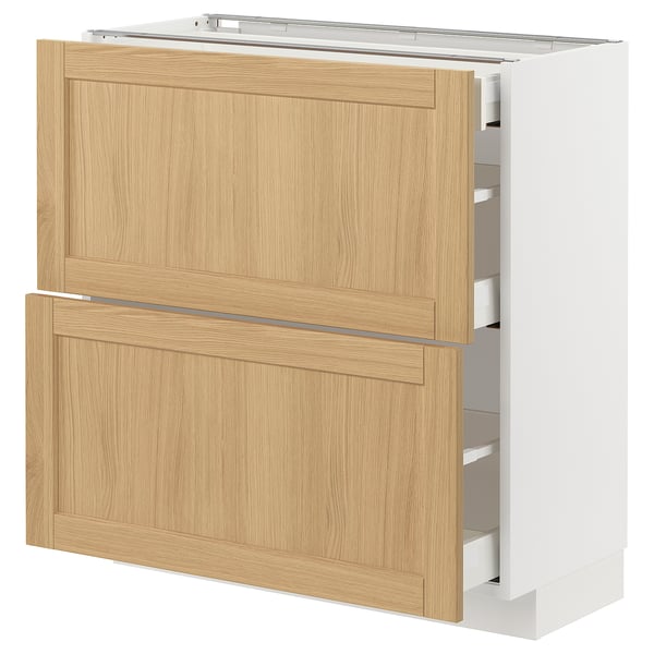 METOD kitchen cabinet with light oak veneer drawers and white base, featuring bevelled edges and sleek design.