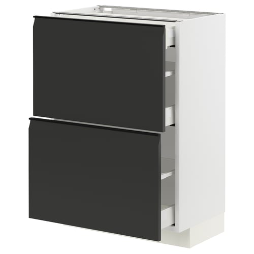 An ikea METOD kitchen cabinet in white with black upplöv drawers. It has a modern, minimalistic design with integrated handles and a chamfered edge.