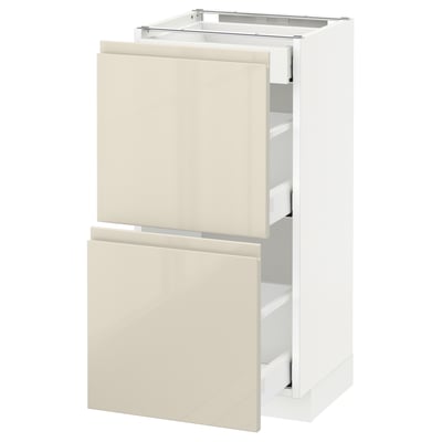 IKEA METOD kitchen unit, white with high-gloss beige drawers, modern and sleek, open display.