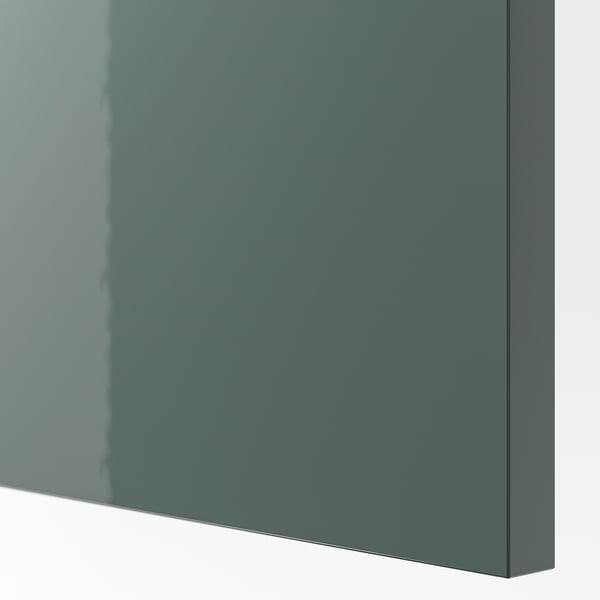 High-gloss gray-green kitchen cabinet close-up. Sleek, modern finish with smooth texture. High-quality, reflective surface.