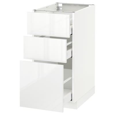 A white high-gloss METOD kitchen cabinet with three open drawers featuring sleek, modern design.