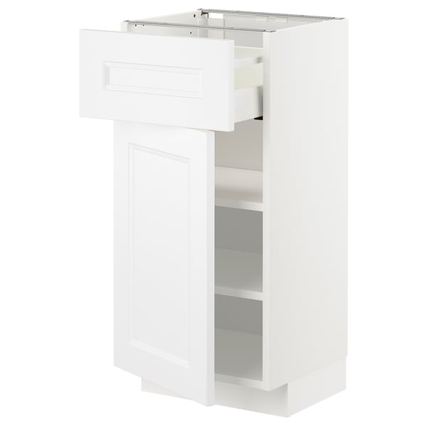 A white METOD kitchen cabinet with a drawer and shelves. Its rectangular, modern, and has a smooth finish.