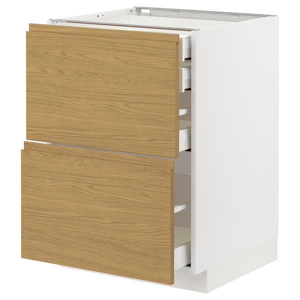 A white METOD kitchen cabinet with light wood-colored drawers in an oak finish and minimalist design.