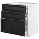 A modern white kitchen cabinet with three black wooden drawers; sleek and organized.