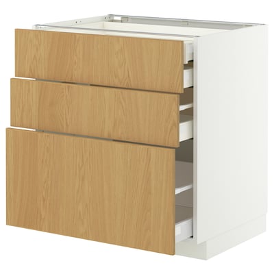 New METOD kitchen cabinet in light wood color, white frame, featuring three drawers with sleek design and smooth finish.