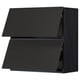Black modern kitchen cabinet, sleek design with angled doors, part of the METOD system.
