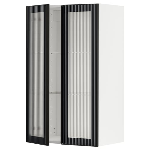 A white METOD kitchen wall cabinet with a black hejsta glass door featuring reeded glass and metal frames with integrated handles.