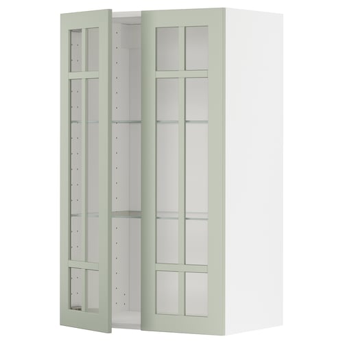 Sage green ikea METOD kitchen cabinet with glass doors and adjustable shelves.