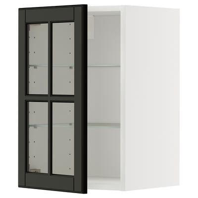An ikea METOD kitchen cabinet with black bodbyn glass doors and a white frame. The cabinet has adjustable glass shelves and a modern design.