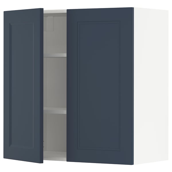 Blue kitchen cabinet with one door open, revealing an empty interior with one adjustable shelf. The cabinet is square-shaped with a modern design.