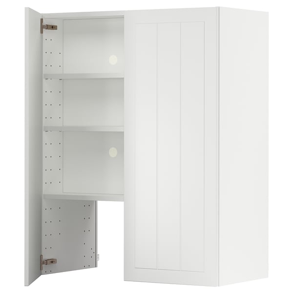 A white METOD kitchen cabinet with an open door, revealing adjustable shelves inside.