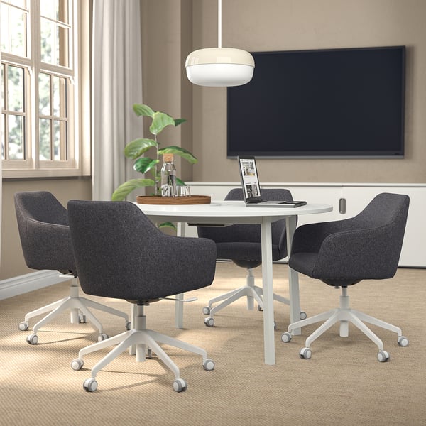 MITTZON conference table with 4 chairs, laptop, plant, tv, natural light.