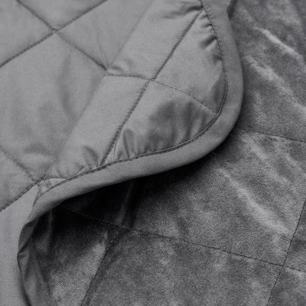 Close-up of velvet bedspread, showcasing smooth texture and detailed stitching.