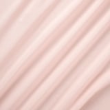 Soft, light pink curtains with a delicate texture, slightly transparent, gently draped.