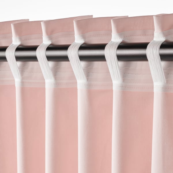 Close-up of sheer pink curtains with white tabs and hooks for hanging on rods, offering light filtration and privacy.