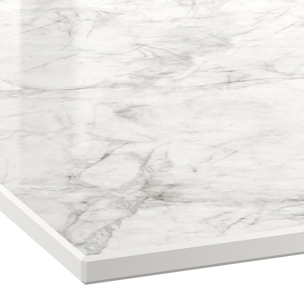 Close-up of a sleek, white high-pressure porcelain worktop with subtle grey marbling patterns, showcasing its smooth, durable, and elegant surface.