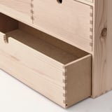 Close-up of MOPPE mini chests sturdy wooden drawers with smooth surfaces and tight joints.