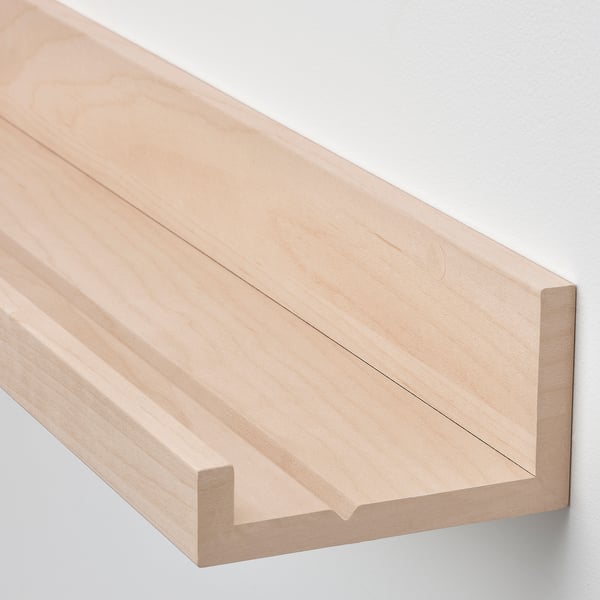 Light wood picture ledge, smoothly finished, attaches to wall for displaying frames.