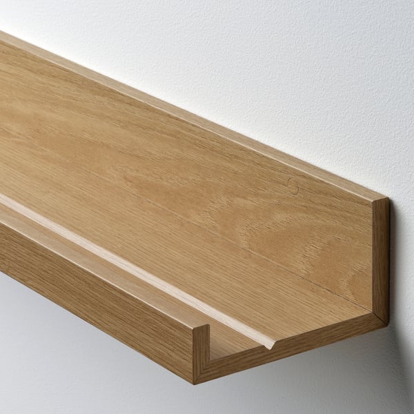 Wooden wall shelf, single piece, light finish, mounted on white wall, showcasing simple, modern design.