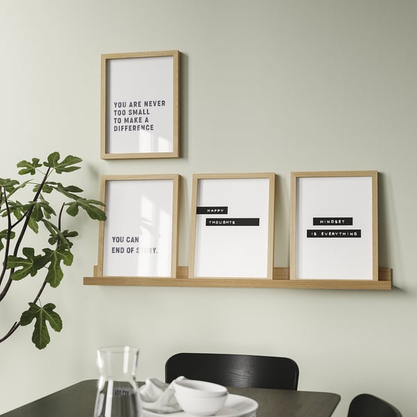 Modern wall-mounted shelf displays four motivational framed prints and a potted plant, providing both decoration and inspiration.