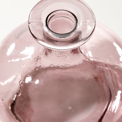 The MYRMOSAIK vase is a handcrafted piece made from purple recycled glass with a rounded, erupting shape and visible air bubbles.