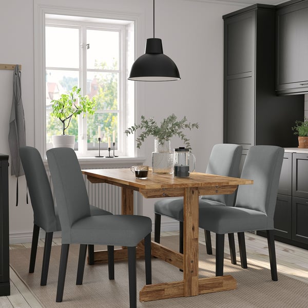 NACKANÄS dining set with rustic table, grey chairs & black pendant light.