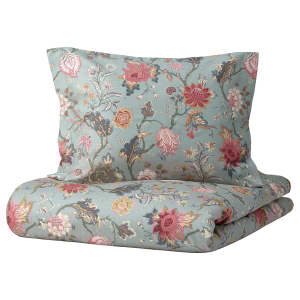 A NÄSSELKLOCKA bedding set in turquoise with colorful floral patterns, including duvet and pillowcases, made from cotton and viscose.