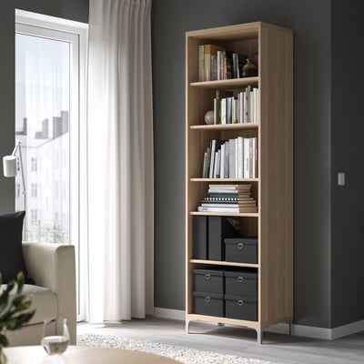 Modern living room with NIMM bookcase, books, and storage boxes.