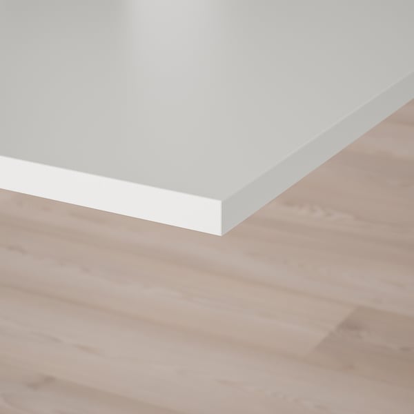 White tabletop on wooden floor; clean, modern design.