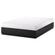 This is an ikea NORDLI bed frame in black with six drawers and a white foam mattress. It offers storage and is ideal for small spaces.