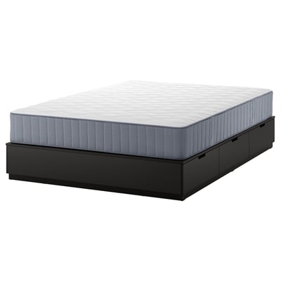 A sleek black NORDLI bed frame with six drawers and a white mattress. Modern, compact design with ample storage.
