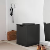 Black IKEA NORDLI drawers with cushion, bag, and boots.