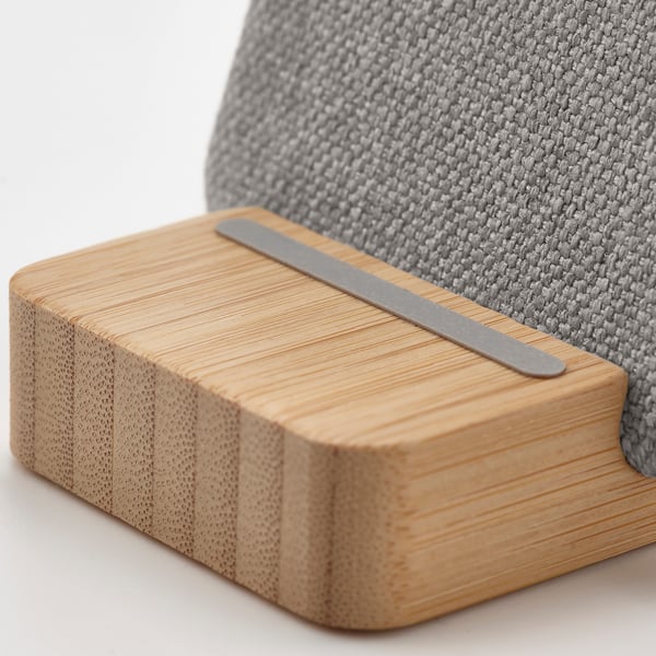 Wireless charging stand with smooth bamboo base and sleek metallic charger, exquisite design.