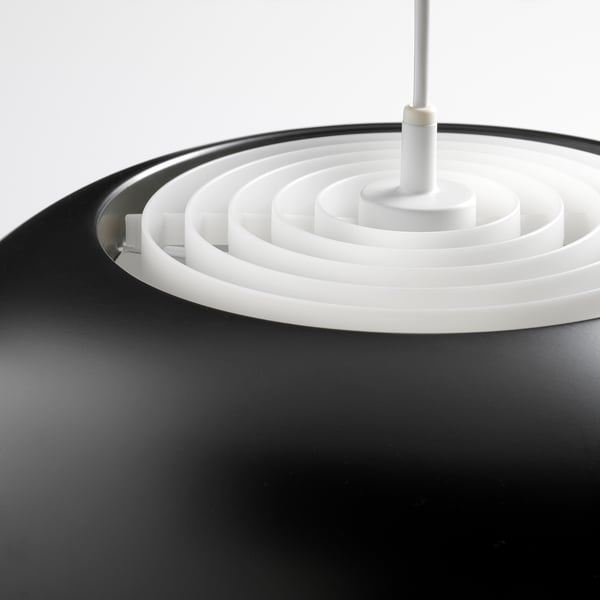 Black modern pendant lamp with white concentric rings, sleek design.