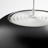Black modern pendant lamp with white concentric rings, sleek design.
