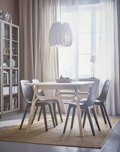 ODGER chair, black, moulded plastic shell with wooden fibres, 4 splayed legs, simple modern design.