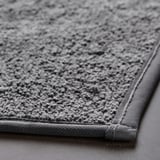 Close-up of a plush, sustainable bath mat with a soft, textured surface and sturdy edges.