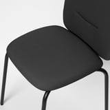 Close-up of modern chair with sleek black metal legs, thick dark fabric seat, and high backrest, showcasing comfort and quality.