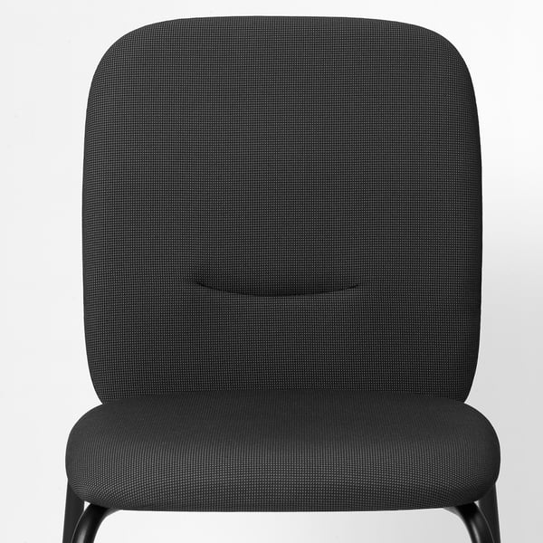 Back and seat of upholstered dining chair shown, featuring thick padding and dark patterned fabric.